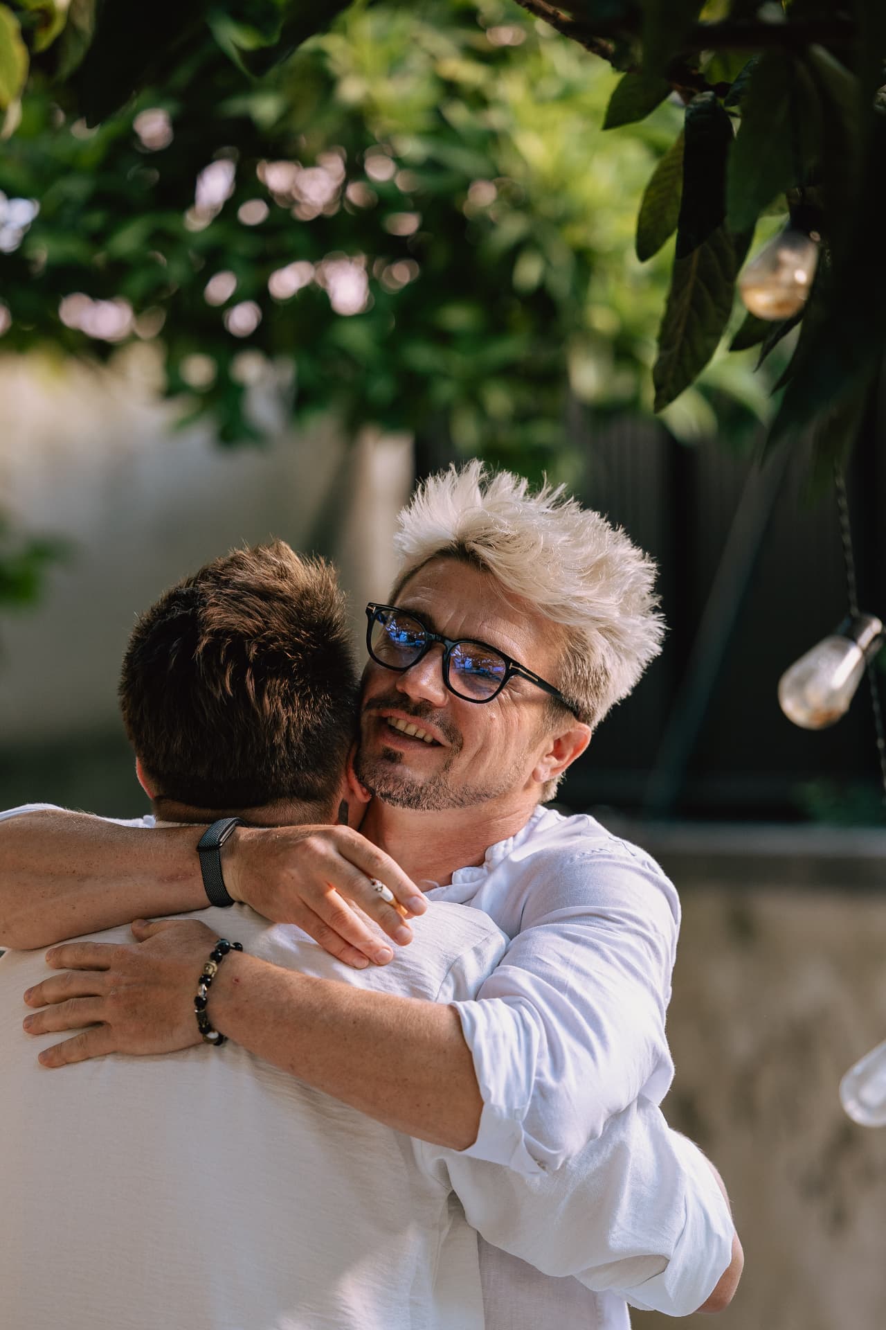 Two guests hugging at a Founders Fire event