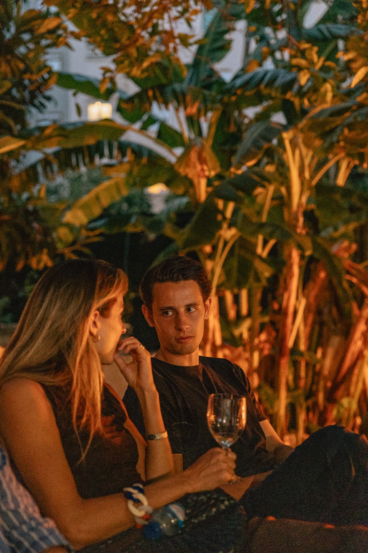 Two guests in conversation by the fire